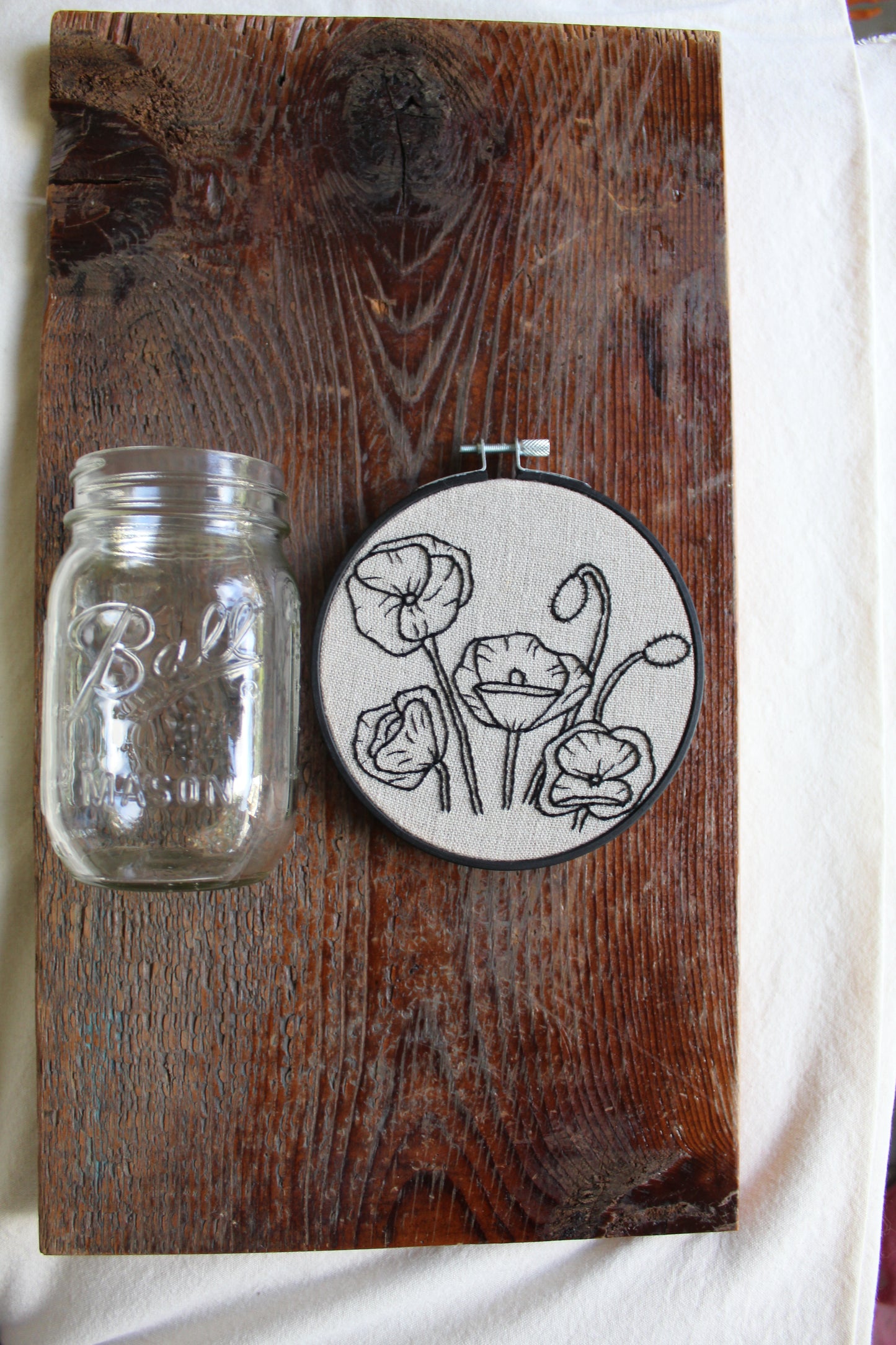 Poppies embroidery, jar for scale, front hoop art